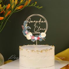 a wedding cake with flowers on top