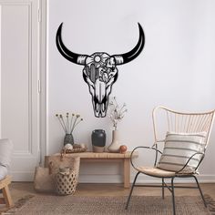 a living room with a cow skull wall decal on the wall and a chair next to it