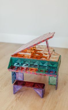 a toy piano sitting on top of a wooden table