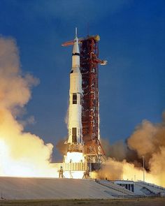 the saturn rocket lifts off into the sky