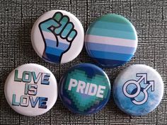 four badges that say love is love and pride