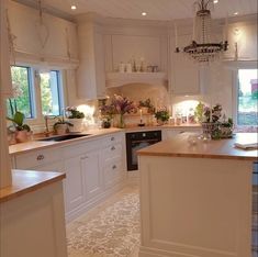 a kitchen with white cabinets and an island