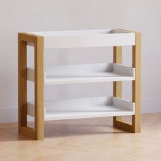 a white shelf sitting on top of a hard wood floor