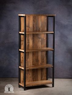 a wooden book shelf with metal legs and shelves on each side, against a dark background