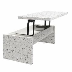 a white table with an open drawer on it's side and the top partially covered in speckles