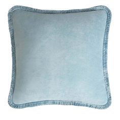 a light blue pillow with fringe trims on the front and back of it, against a white background