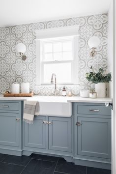 a kitchen with blue cabinets and white appliances