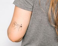 a woman with a small tattoo on her arm