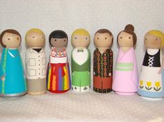 a group of wooden dolls standing next to each other