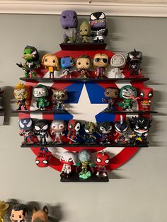 a wall mounted shelf filled with lots of action figures and figurines on top of it