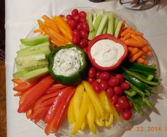 a platter filled with assorted veggies and dip