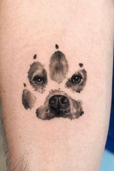 a dog's paw print is shown on the right arm and chest, with black ink all over it