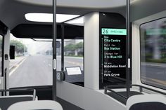 the interior of a public transit bus with its doors open and seats facing towards the street