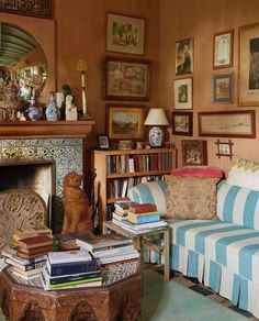 a living room filled with lots of furniture and books on top of a wooden table