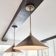 two lights hanging from the ceiling in a kitchen