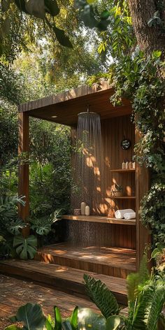 an outdoor shower surrounded by greenery and trees