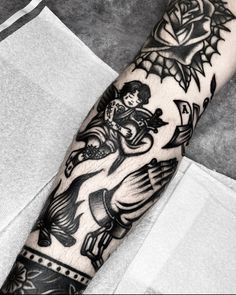 a black and white photo of a person's arm with tattoos on the arm