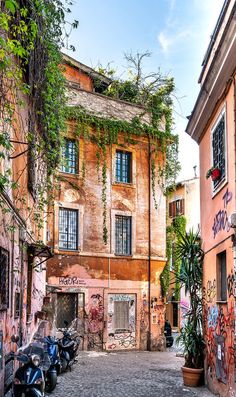 an old building with vines growing on it's side and motorcycles parked in front