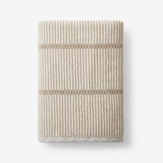 a white and beige striped towel on top of a table