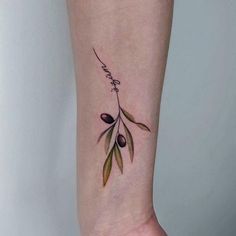 an olive branch tattoo on the ankle