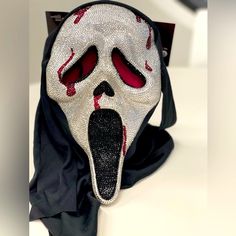 a white mask with red eyes and tongue sticking out