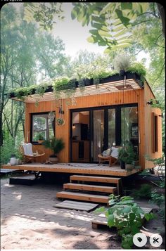 a small wooden cabin in the woods with steps leading up to it