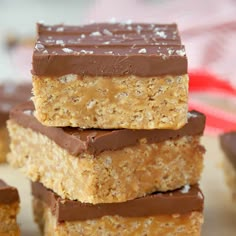 three pieces of chocolate peanut butter bars stacked on top of each other