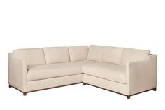 a white sectional couch sitting on top of a wooden frame