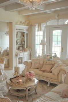 a living room filled with furniture and a chandelier