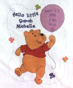 a winnie the pooh baby blanket with a balloon on it's chest and name