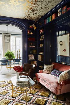 a living room filled with furniture and bookshelves