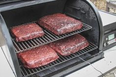 three hamburger patties are cooking on the grill