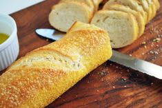 a loaf of bread sitting on top of a cutting board next to a knife