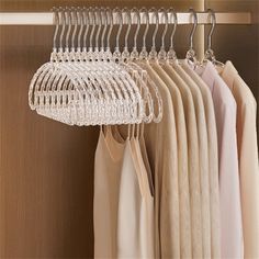 a closet with clothes hanging on hangers