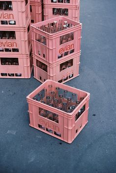 several pink crates stacked on top of each other