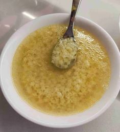 a bowl of soup with a spoon in it