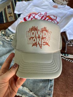 The "Howdy Honey" Trucker Hat is a charming blend of sweet and sassy! Featuring a fun and playful design, this hat is perfect for showing off your friendly Western spirit. With its comfortable fit and stylish mesh-back design, it’s an adorable accessory for cowgirls who love to spread good vibes wherever they go! One Size Fits Most Patriotic Tees, Slides Slippers, Western Hats, Plus Size Shopping, Boys Jacket, Playful Design, Long Sweaters, Turquoise Jewelry, Hat Hairstyles