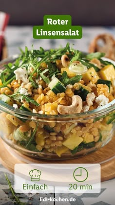 a glass bowl filled with food on top of a wooden cutting board