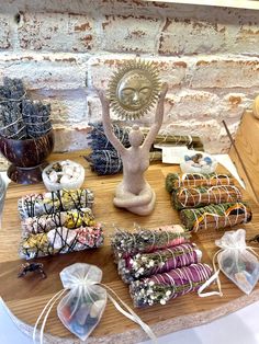 a wooden table topped with lots of different types of wrapped goods and bags on top of it