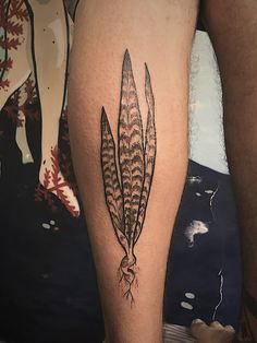 a close up of a person's leg with tattoos on it and an arrow