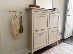 a white dresser sitting next to a doorway