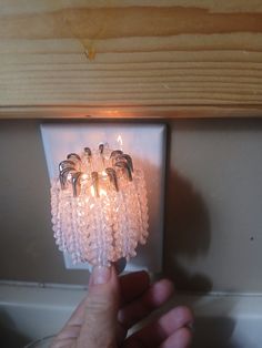 a hand is holding a light switch with several lights on it