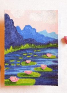 an acrylic painting of water lillies and mountains in the distance with pink flowers