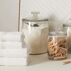 several glass jars filled with different types of wood shavings next to each other