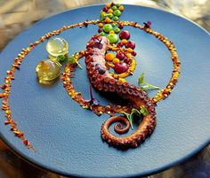 a blue plate topped with an octopus covered in candy