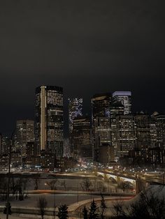 the city skyline is lit up at night