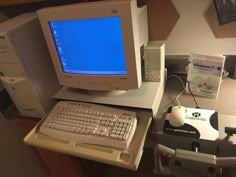 an old computer sitting on top of a desk next to a mouse and keyboard,