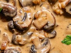 mushrooms are in a creamy sauce on top of bread