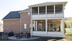 a large brick house with a covered patio