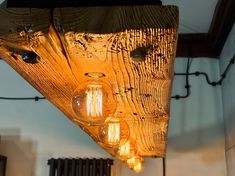 a wooden light fixture hanging from the ceiling